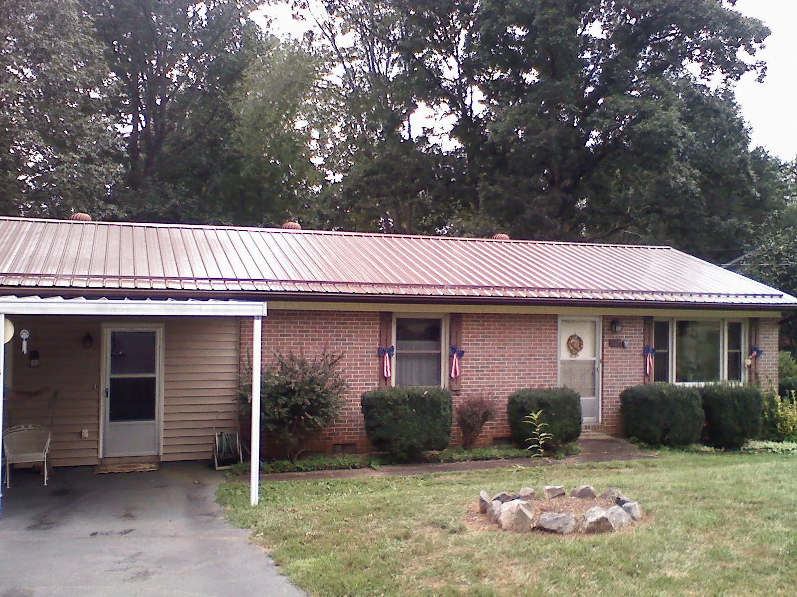 Bronze metal roof and carport on a brick ranch home — Roof Repair work by our crew in East Walpole